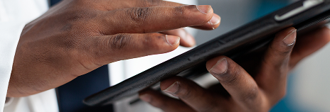 closeup-african-american-doctor-holding-tablet-computer-typing-healthcare-treatment-after-analyzing-disease-symptoms-clinical-appointment-therapist-man-working-hospital-office 1